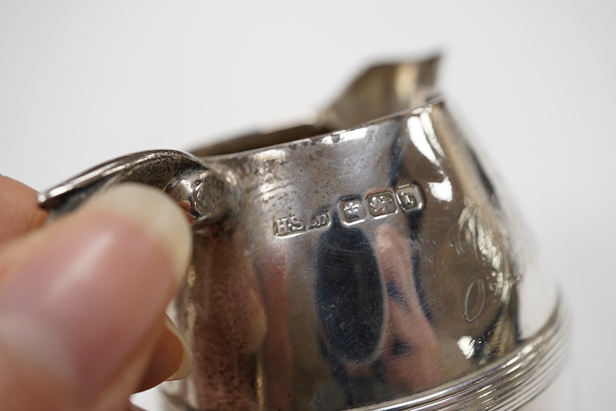 An Edwardian silver three piece bachelor's tea set, with reeded band, by Henry Stratford Ltd, Sheffield, 1909, gross weight 19oz.